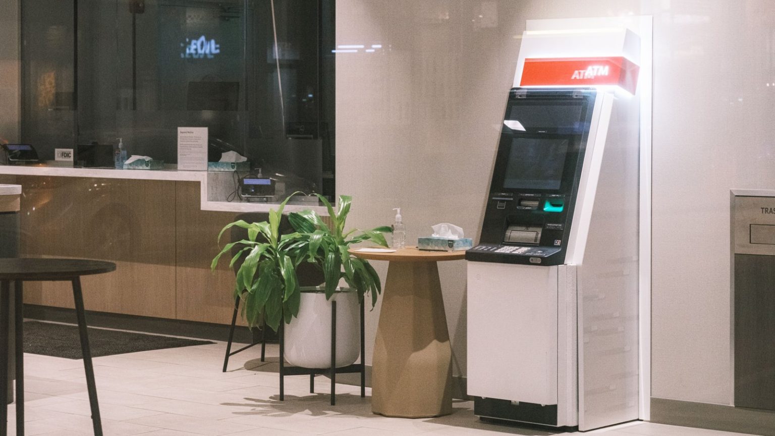 Ken Raymie on Practical AI Applications for Community Banks ATM in a modern bank lobby
